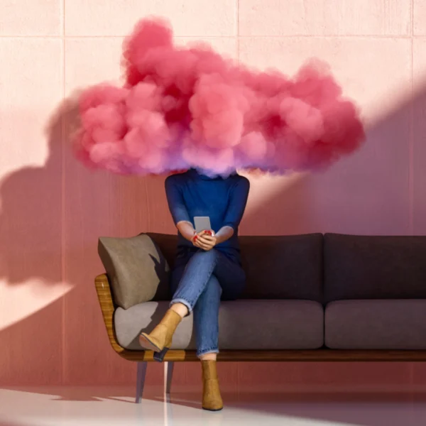 Person sitting on a couch with a smartphone, their head replaced by a cloud of pink smoke — symbolizing mental fog or cognitive overload in the digital age.