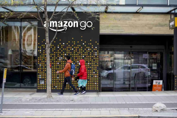 Amazon Go store entrance with customers, highlighting innovative retail experience.