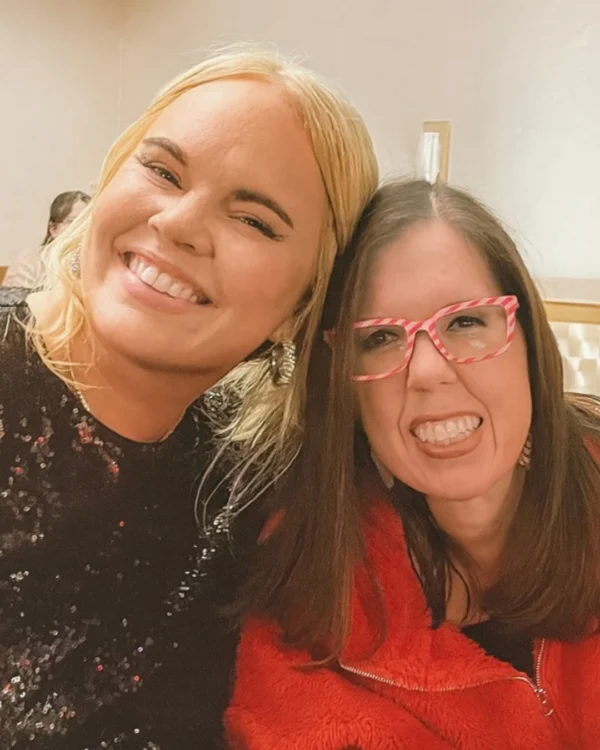 Two women smiling at a social media marketing event in Central Arkansas.