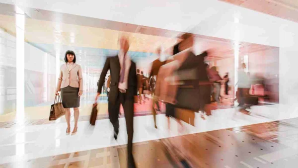 Business professionals walking in a modern office, emphasizing digital marketing strategies.